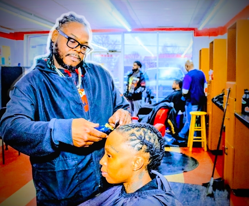 Deon cutting a client's hair at Big Tyme Barbers
